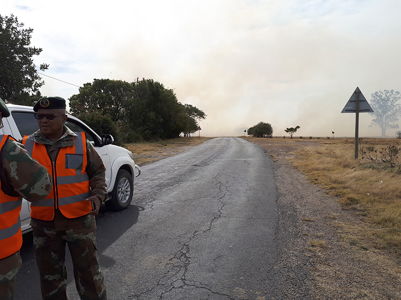 Staff from 6SAI man a roadblock on the army base road, ahead of the spot shere the fire wastearing across towards Cradock Heights.