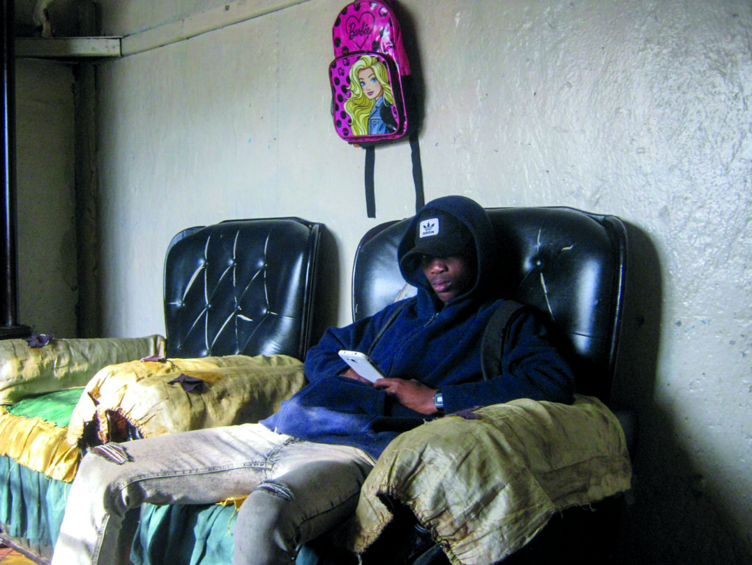 Likho Funani relaxes at his friend’s house in Daniel Street, Joza. He waits to meet up with a girl. © Siphamandla Boma.