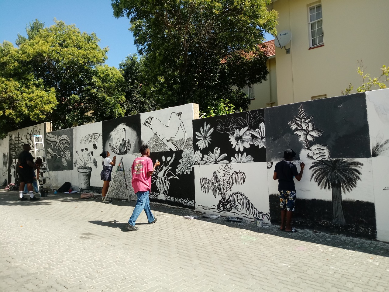 On Rhodes’ campus, next to the main library – students taking fine art as a minor subject manage to create detailed work on a rough surface.