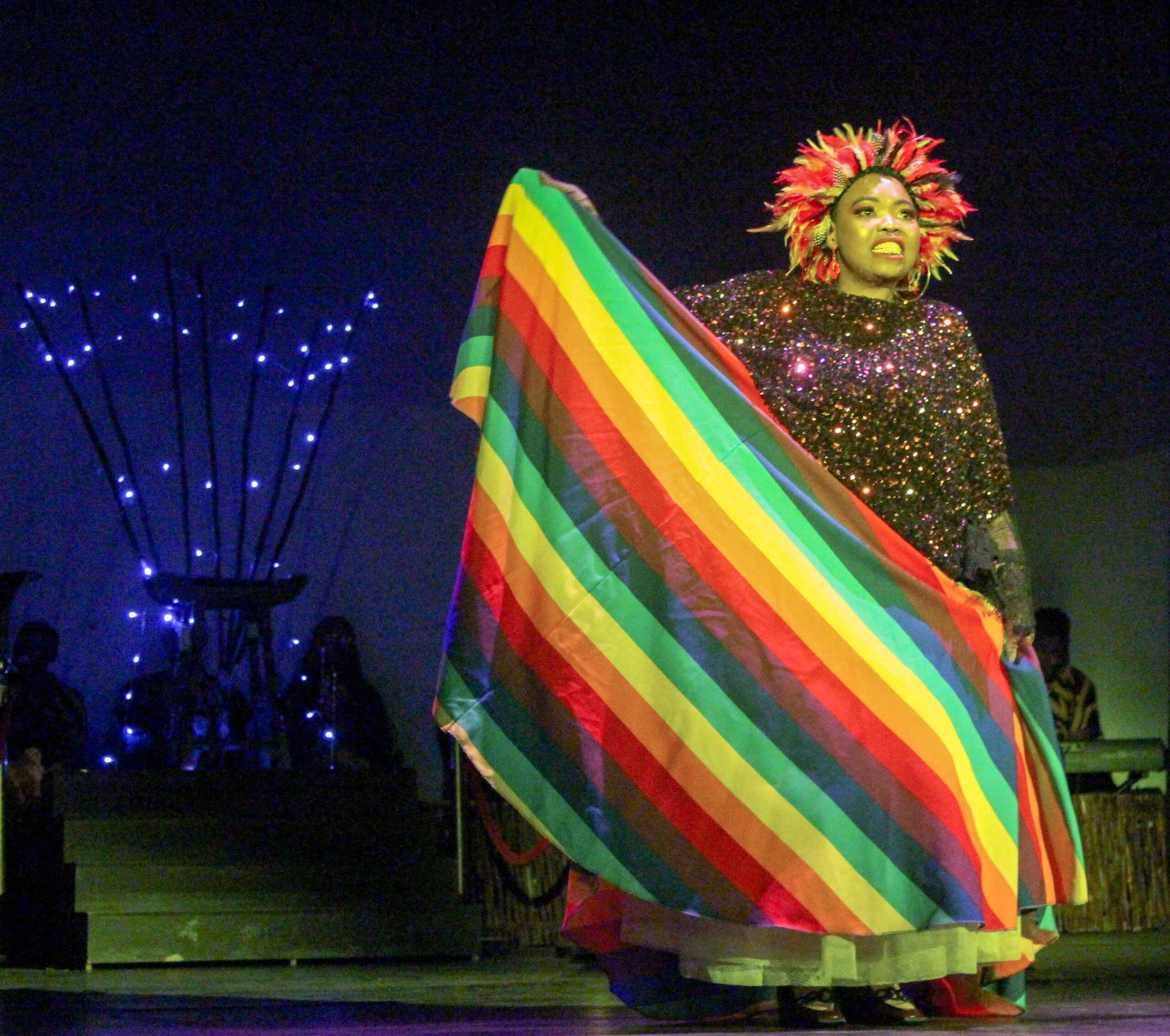 The lady with the pride flag dress is the character Ruffled Feathers.