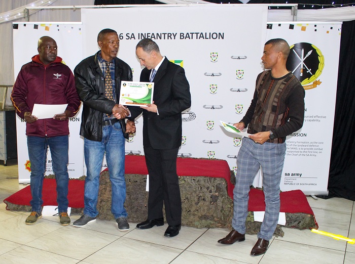 Lieutenant Colonel B. Miller. (third from left) giving certificate for overall team achievement. Photo: Fahdia Msaka