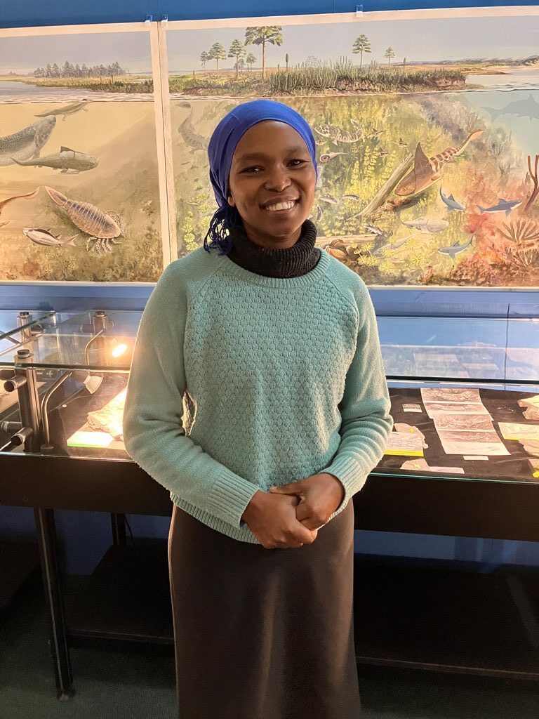 Khokela Camagu, Outreach Officer of the Devonian Ecosystem Project, is happy to guide visitors around the incredible display of fossils and paintings.