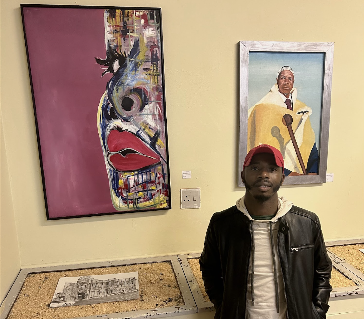 Mabongo poses beside his favourite curated artwork within the exhibition. Photo: Ruvesen Naidoo 