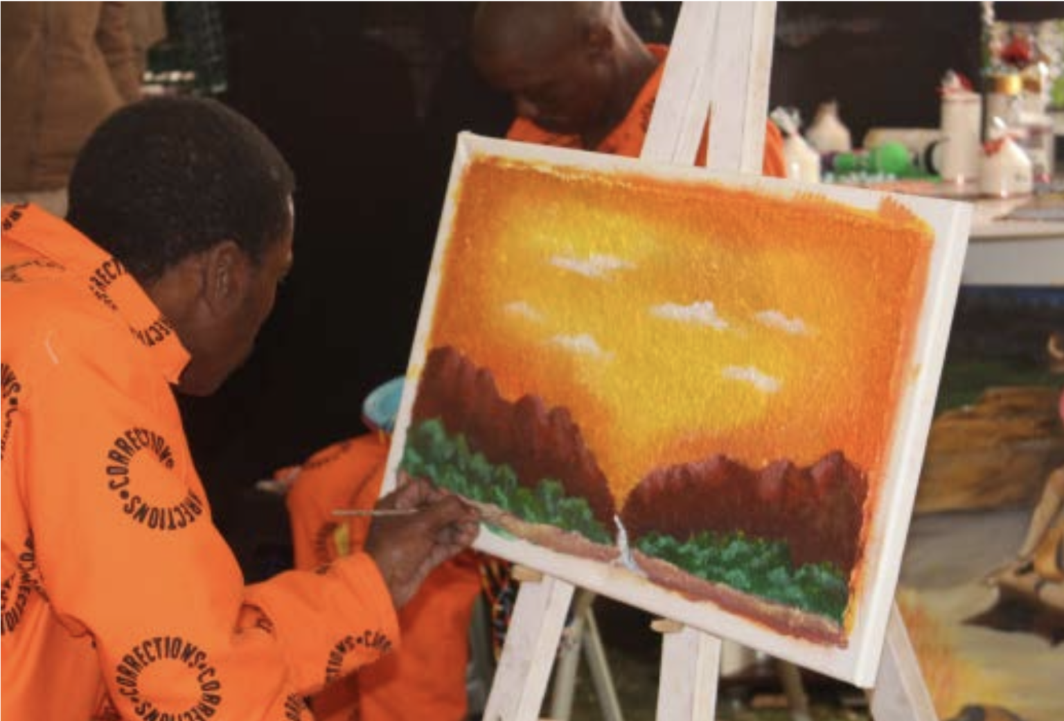 Eric Xakawe making a painting in front of an audience. Photographed by Ovayo Milisa Novukela