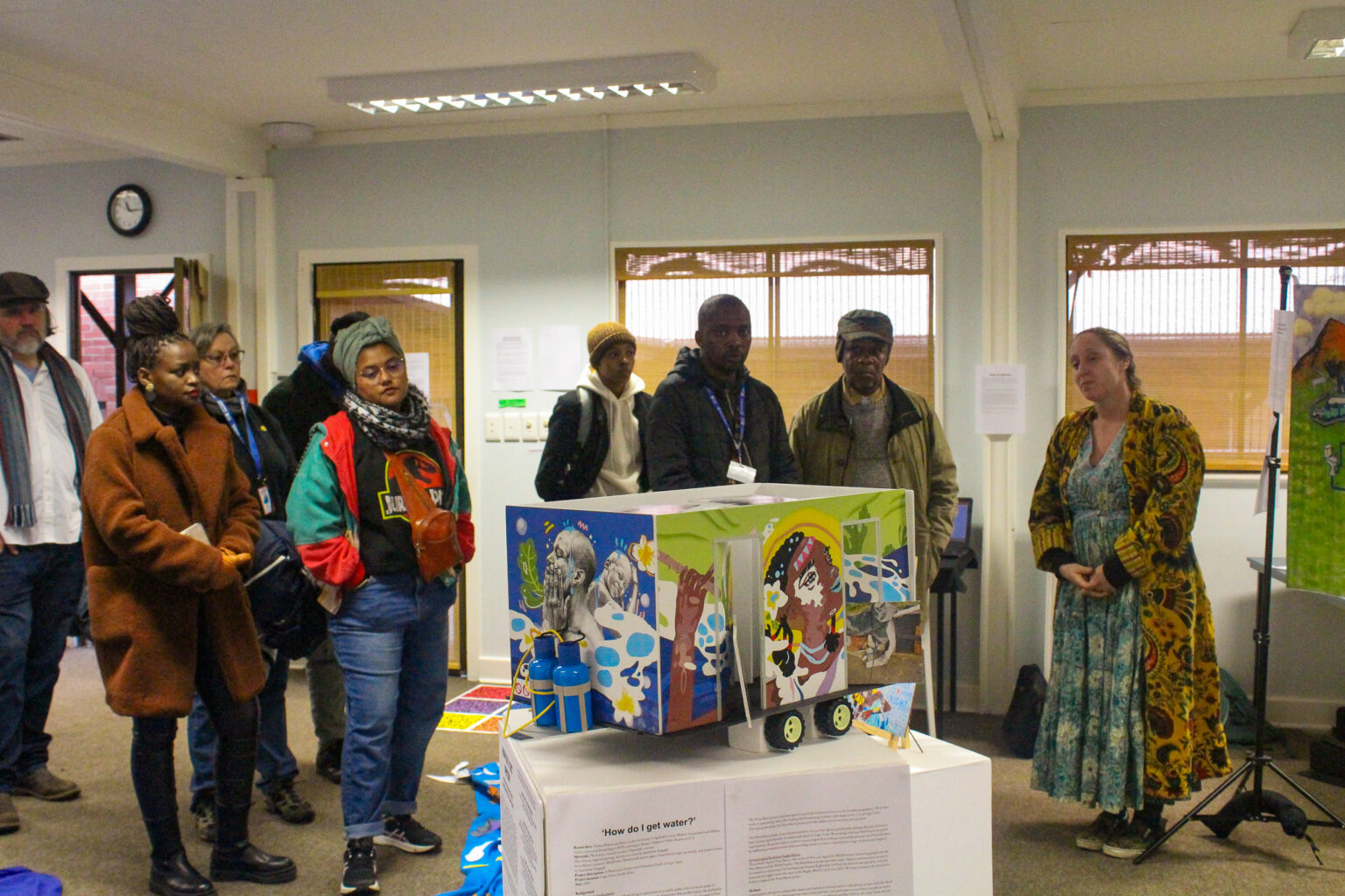 Spectators engage with the curator at the Confluency exhibition Photo: Sisipho Pinyana