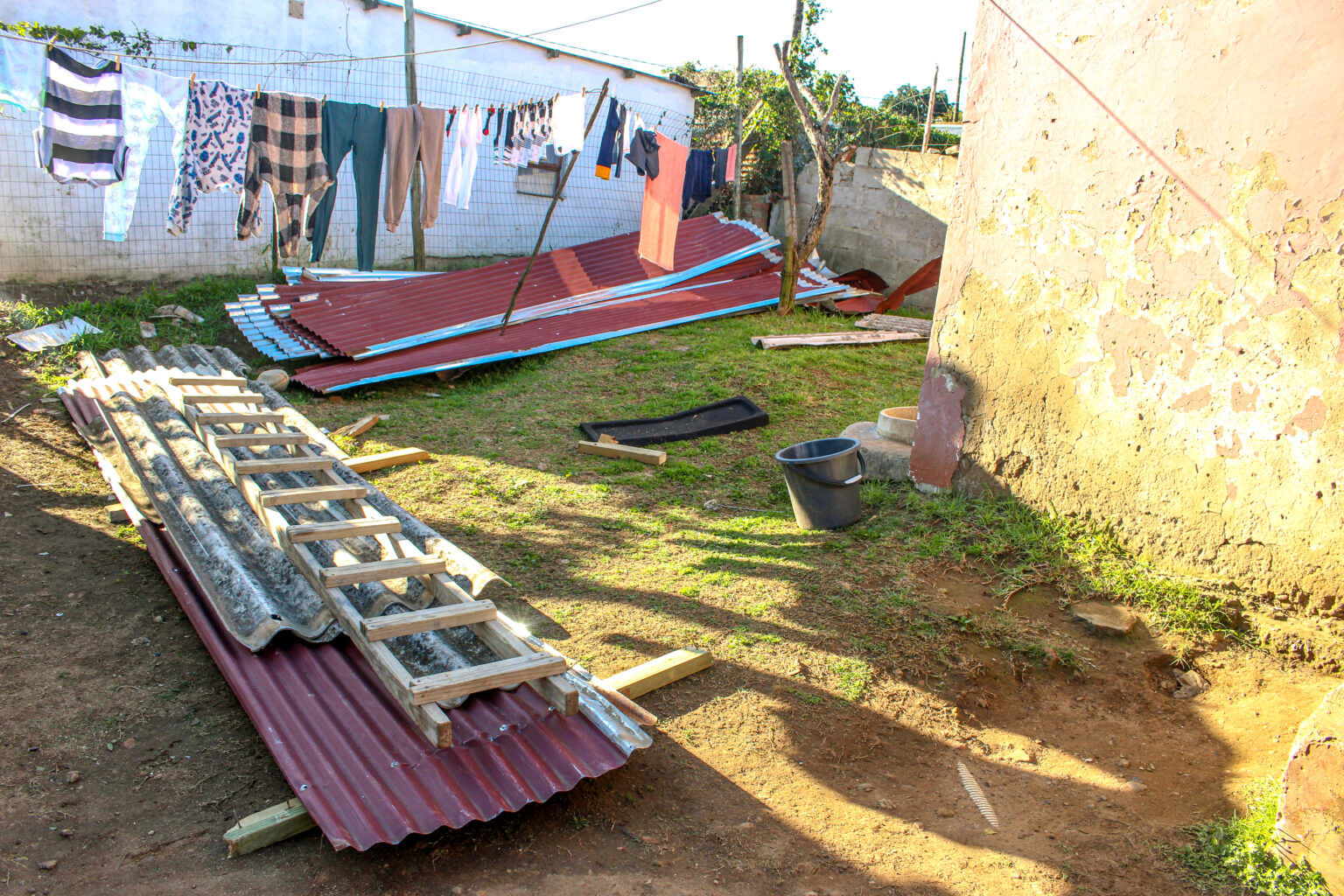 The material from the roof laying in the yard.