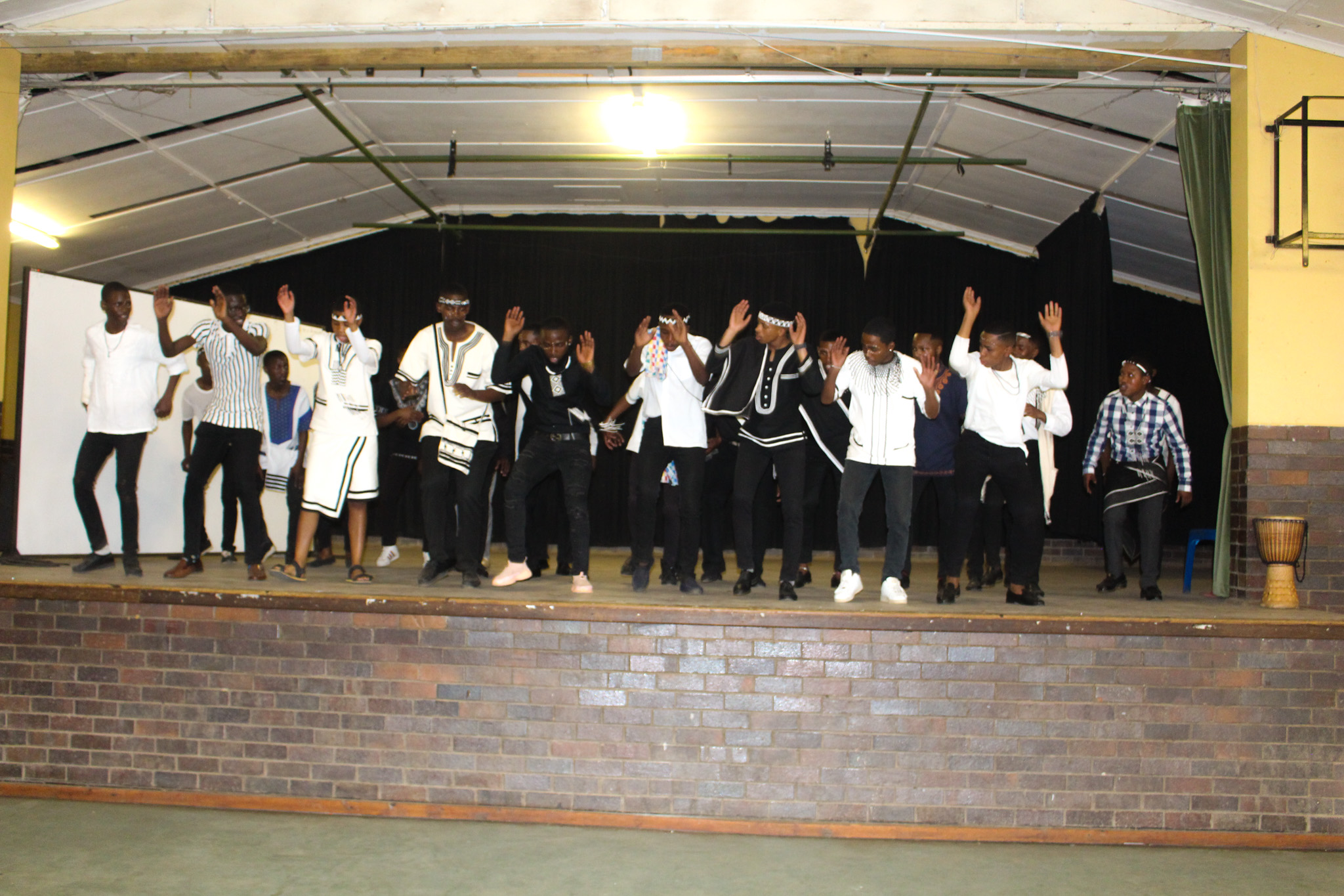 Makhanda Youth Choir male voices preforming on stage.
