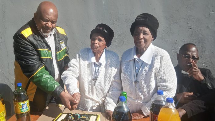 Mama Ngquse cutting her birthday with Councillor Xonxa and friend. Photo: Sourced