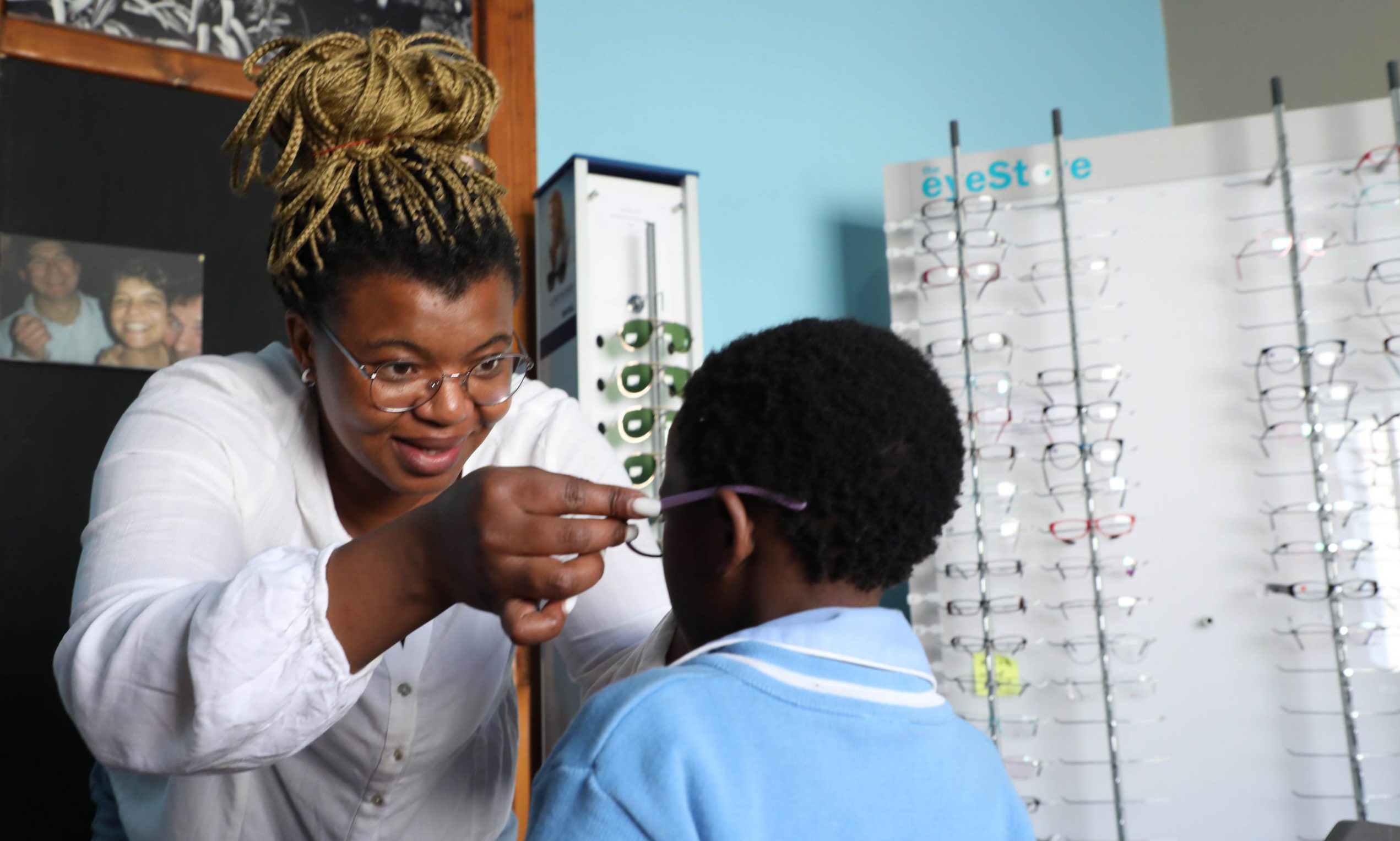 Yamkela Ngxangxeni from Davies Optometrists fits glasses on a child as part of a plan to make sure that all children under 18 have access to glasses if they need them. Photo: Jackie Clausen
