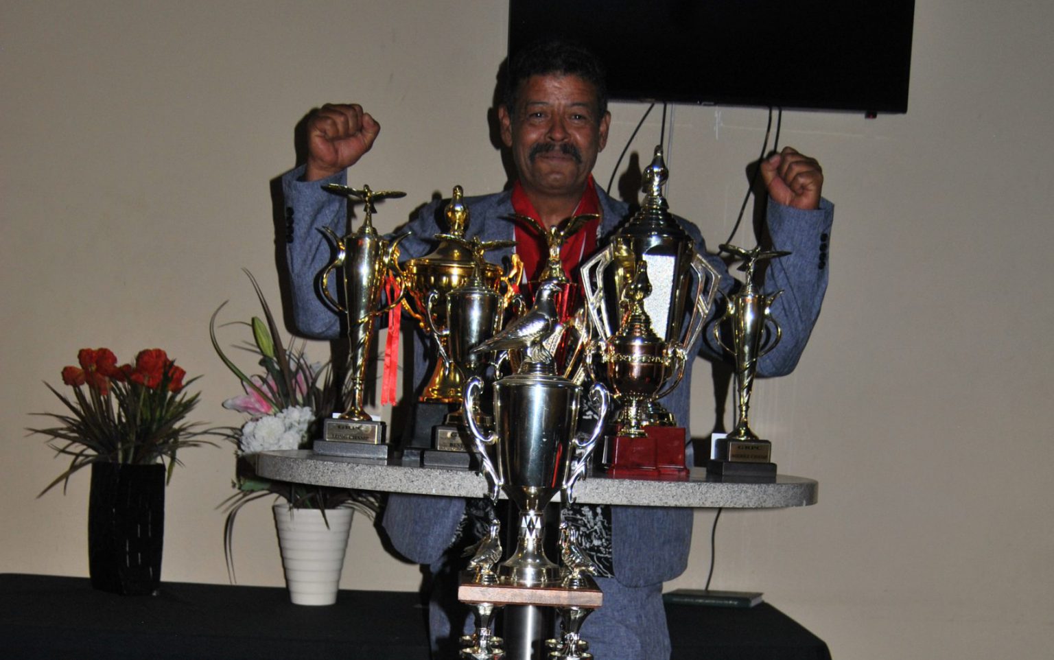 Ciske Mckaizer the Undisputed Grahamstown Racing Pigeon Club Champ showing off his awards at the Annual Prize-giving of the Club.