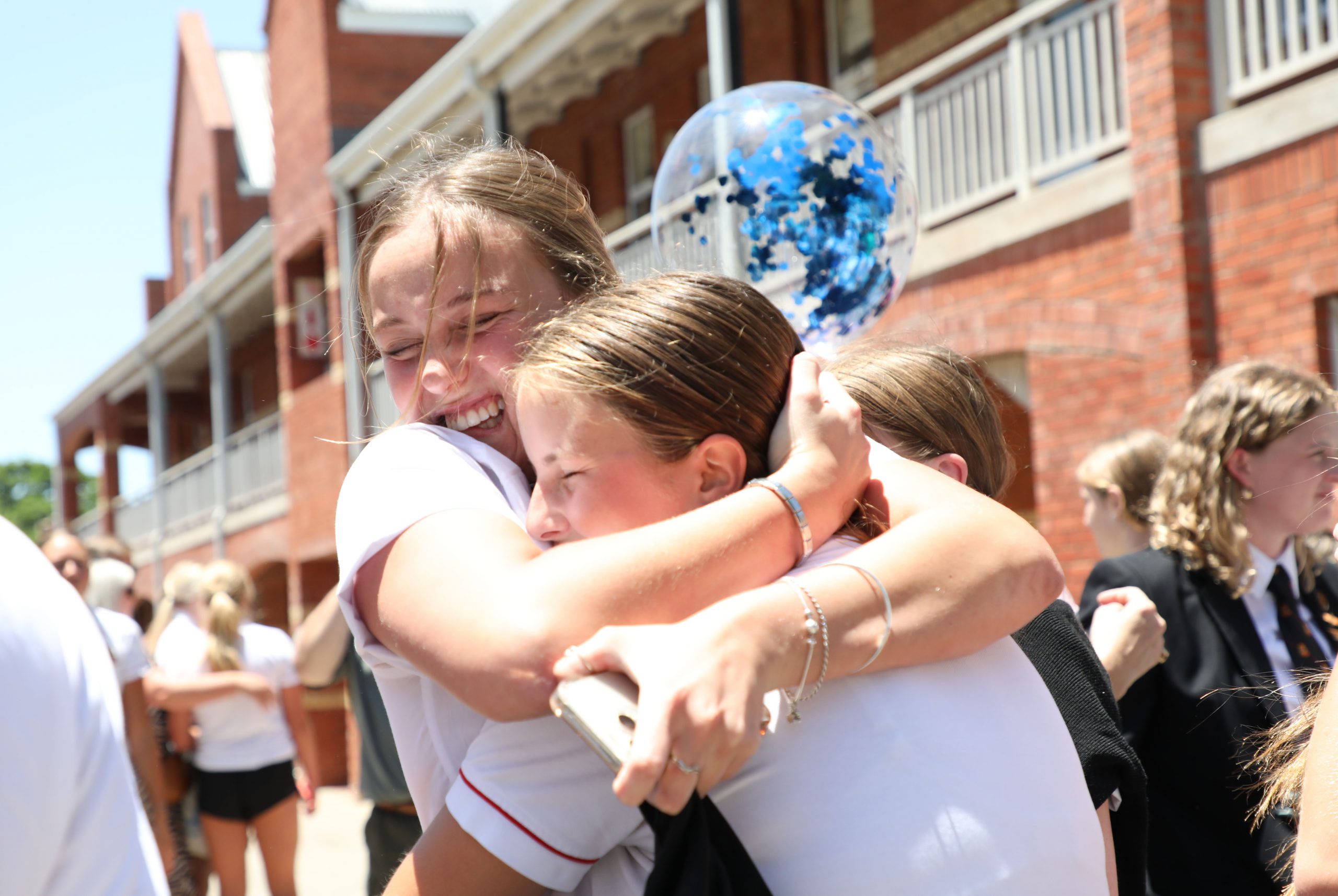 Kigswood College Matriculant Jamie Lacy hugs her Junior Megan Fletcher after her final exam Photo: Jackie Clausen