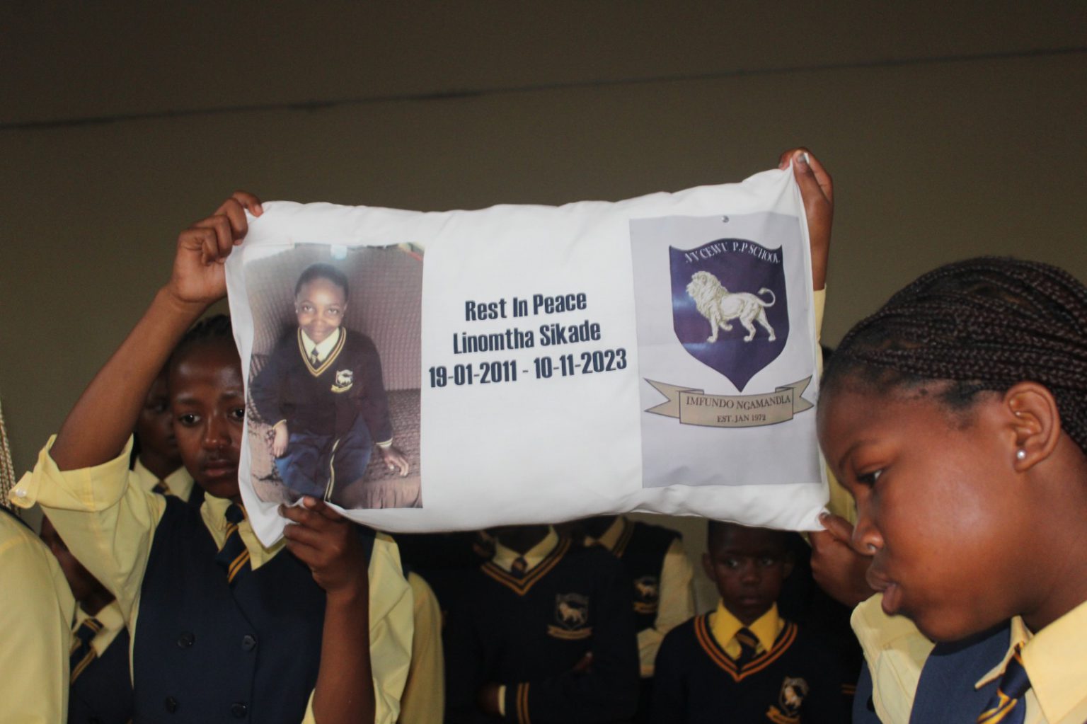 NV Cewu HP School learners holding Linomtha's picture during her funeral. Photo: Chris Totobela