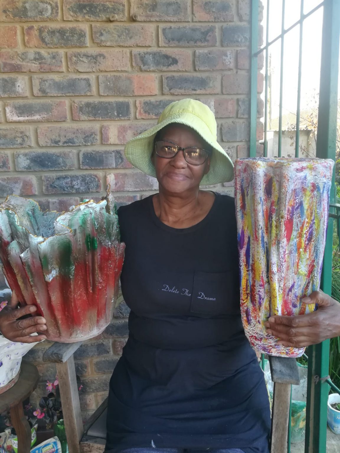 Pumla Cagwe holding two of her sculptured pot plants. Photo: Camagwini Mpendu