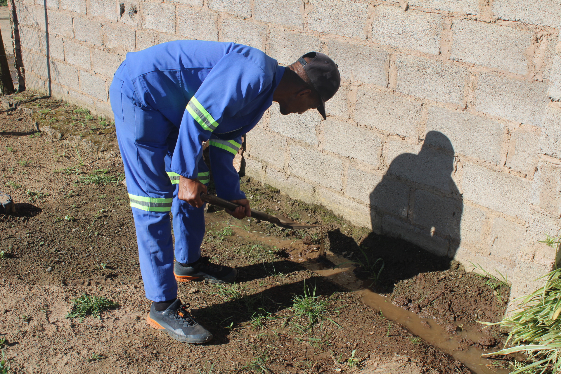 Sipho Songongo, extension 8 resident who was also affected by sewage, fixing his yard.
