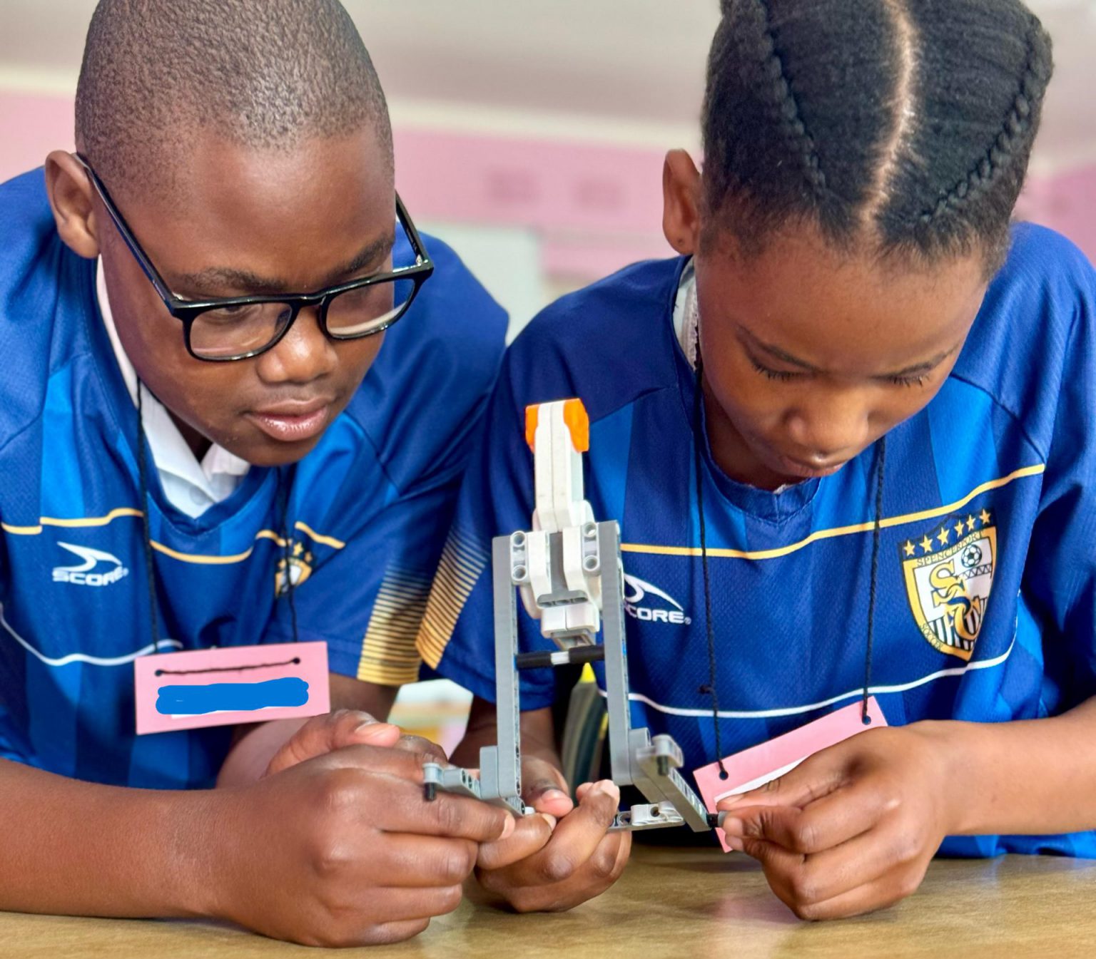 Teamwork: A tech team in Grade 6 collaborate to create a robotic arm that will respond to different intensities of “golf swings”. Photo: supplied