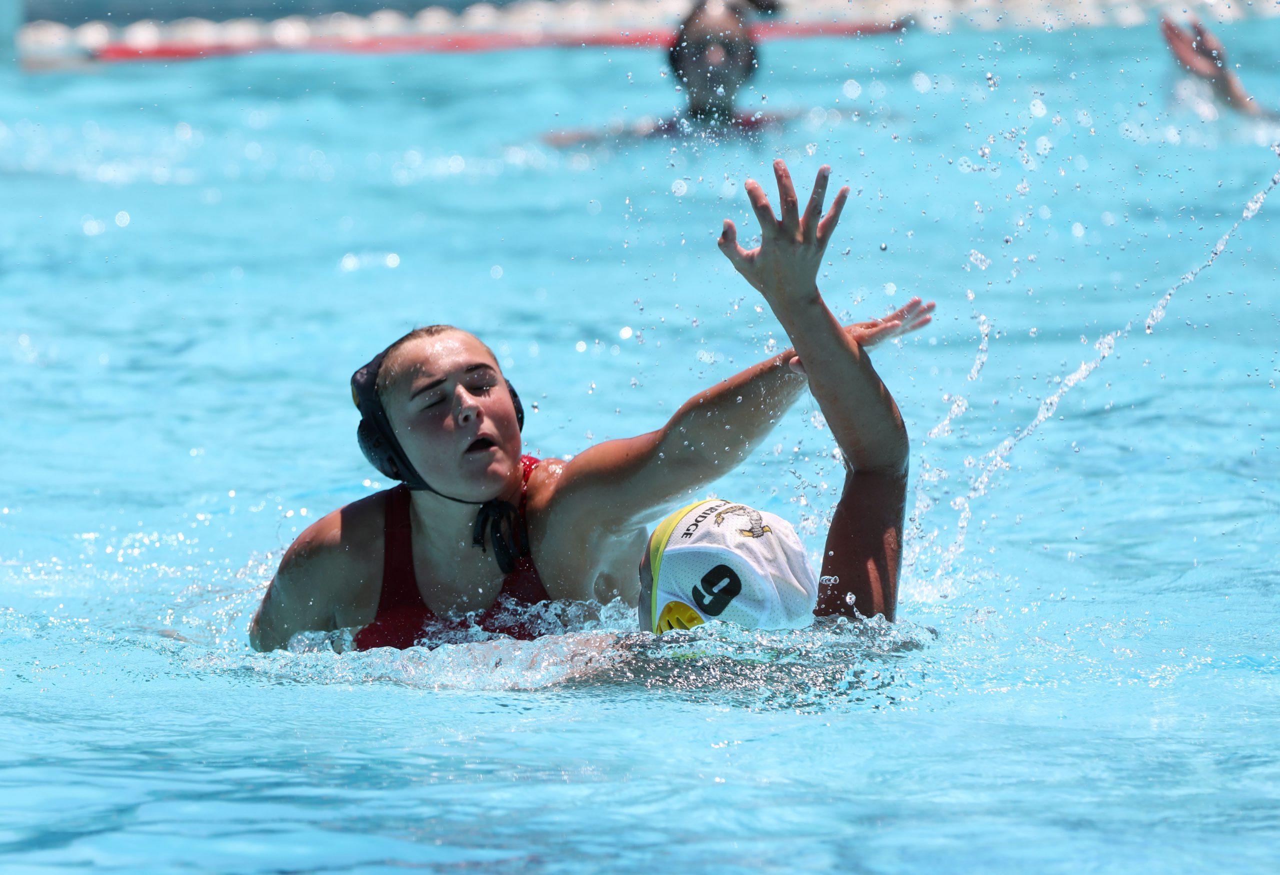 KIngswood College 1st Team Water Polo player Lucy Nagel gets the ball away from a Woodridge player. Kingswood won 18-2 in the opening game in the Brian Baker tournament held at Kingswood College. Photo: Jackie Clausen