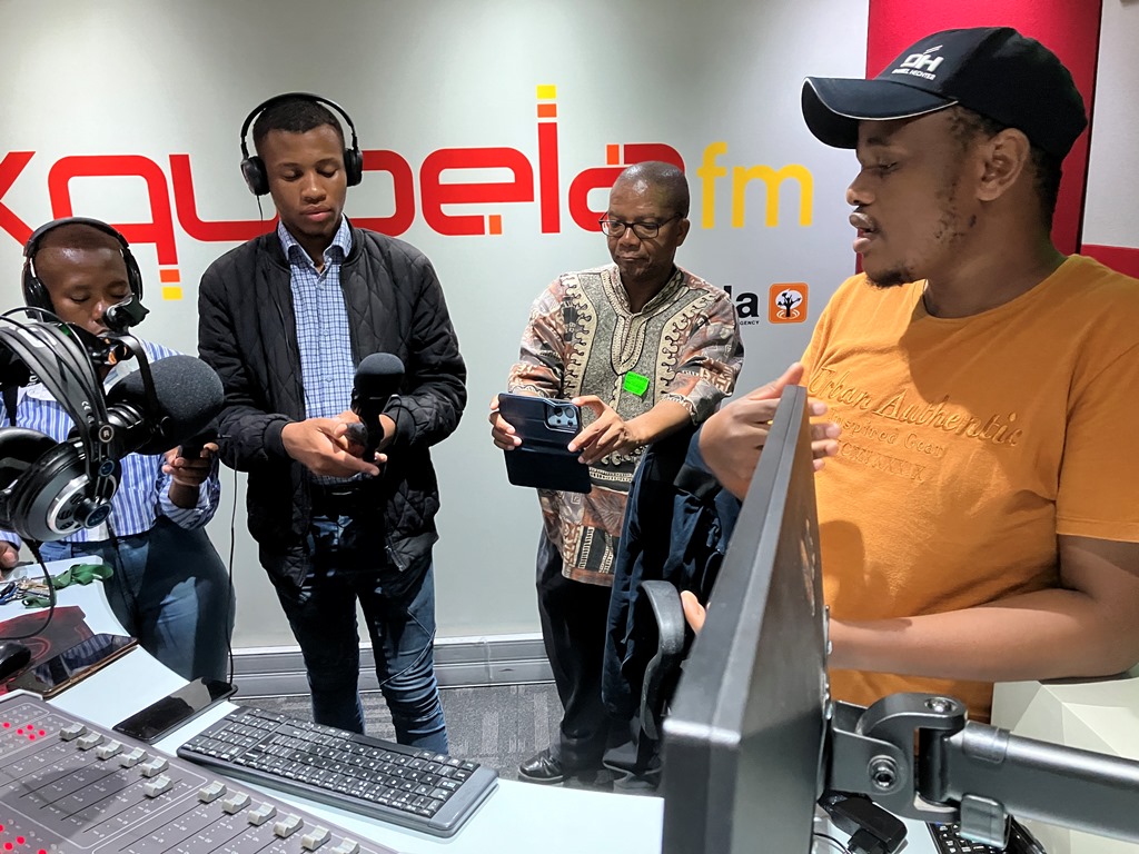 Two radio students and their lecturer Shepi Mati (centre) record the presentation of Nqubela FM Programme Manager, Sivuyile Rasi in KwaDwesi. Photo: Steven Lang