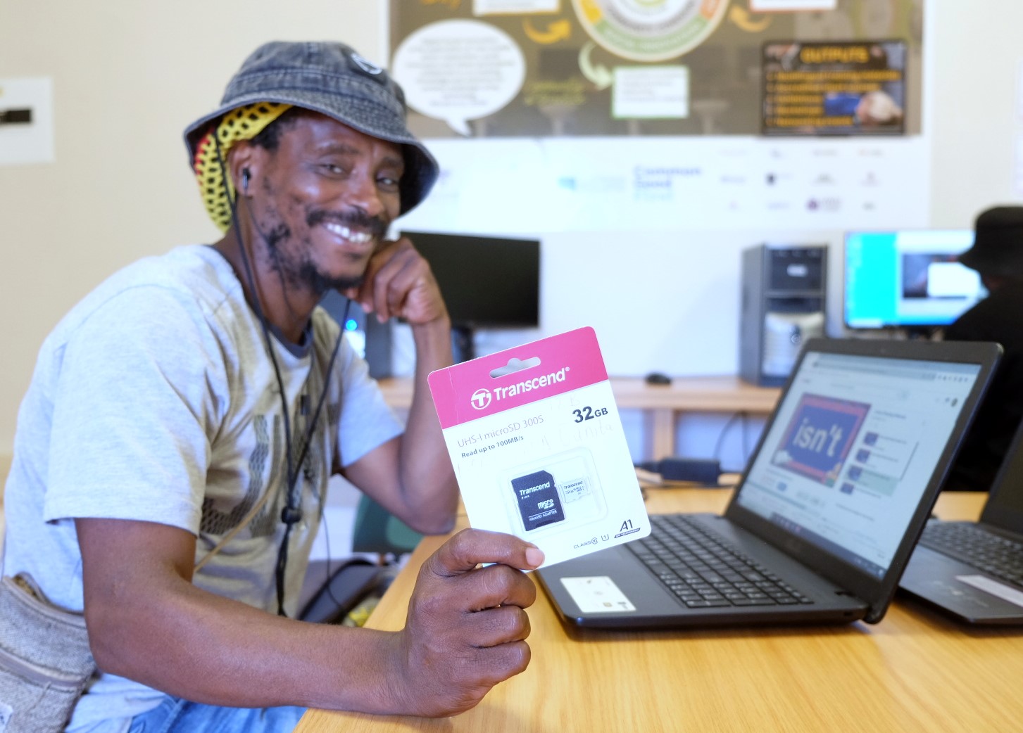 Social Employment Fund (SEF) worker Lindani Donyeli shows off an SD card at the Social Innovation Hub at the Rhodes University Community Engagement centre. Photo: Rod Amner