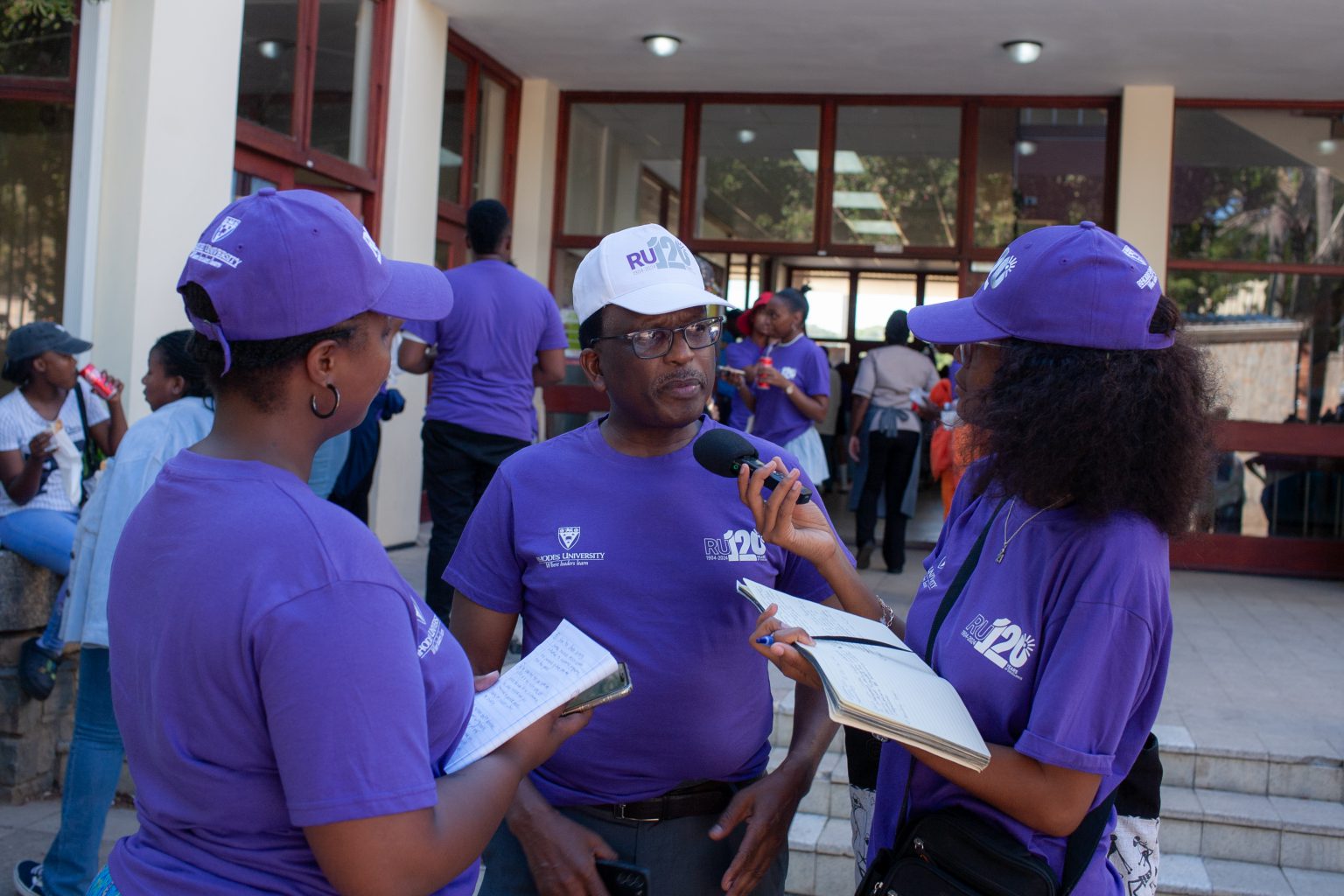 Grocott's Mail journalists, Anga Bushwana (left) and Nothando Tshuma (right), interviewing Rhodes vice chancellor Professor Sizwe Mabizela (centre) at the Great Field for the RU120 formation. Photo: Rikie Lai