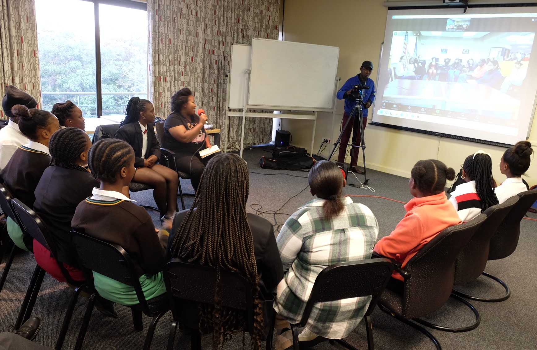 Inkululeko’s Nosi Dosi holds the mic while Awarenet’s Kamvelihle Gule operates the camera during the podcast on 27 February in the Africa Media Matrix at Rhodes University. Photo: Rod Amner