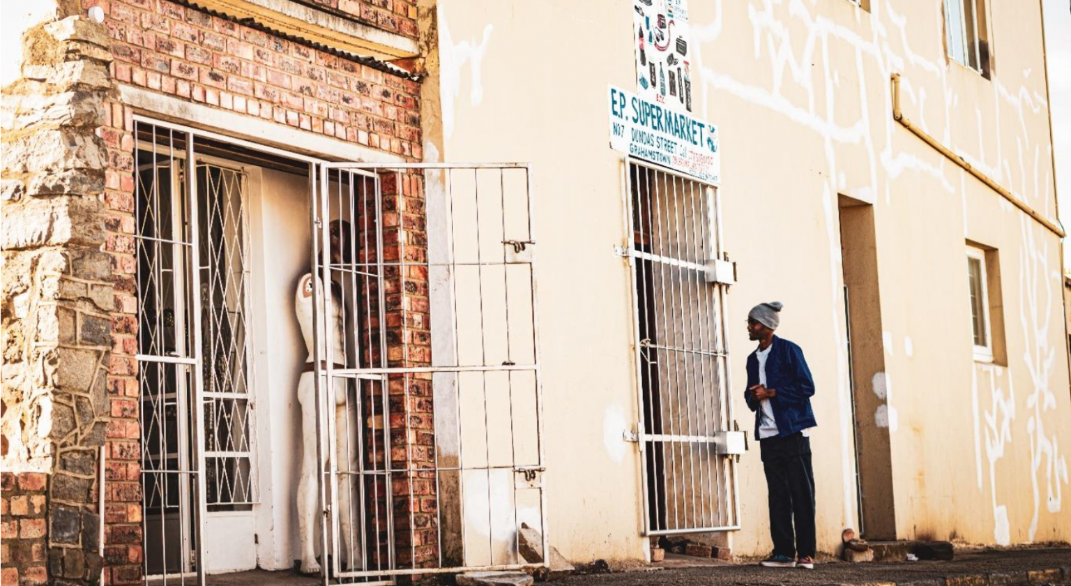 A passer-by greets shop owner, trading next door to Isaias’ clothing store. The store is situated on Dundas Street. Photo: Siqhamo Jama