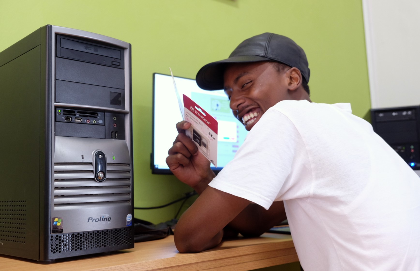 Social Employment Fund (SEF) worker Siyabonga Stwayi shows off an SD card at the Social Innovation Hub at the Rhodes University Community Engagement centre. Photo: Rod Amner