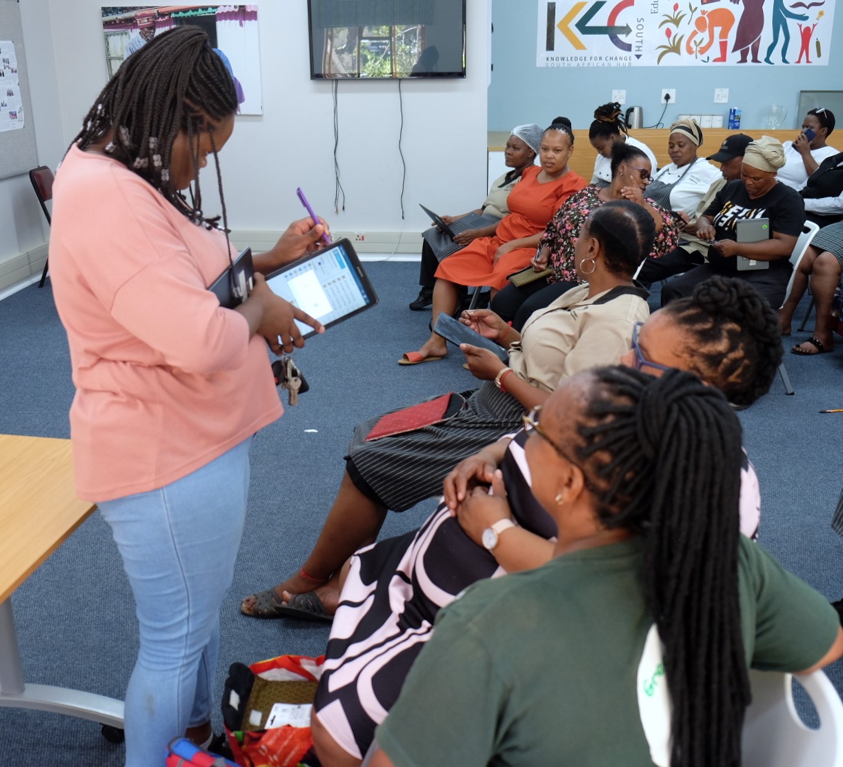 Vulindlela project coordinator Thadiswa Nqowana inserts an SD card into a tablet during a workshop for Vuli’ndlela members at the Knowledge for Change (K4C) Hub at the Rhodes University Community Engagement centre on Wednesday, 14 February. Photo: Rod Amner