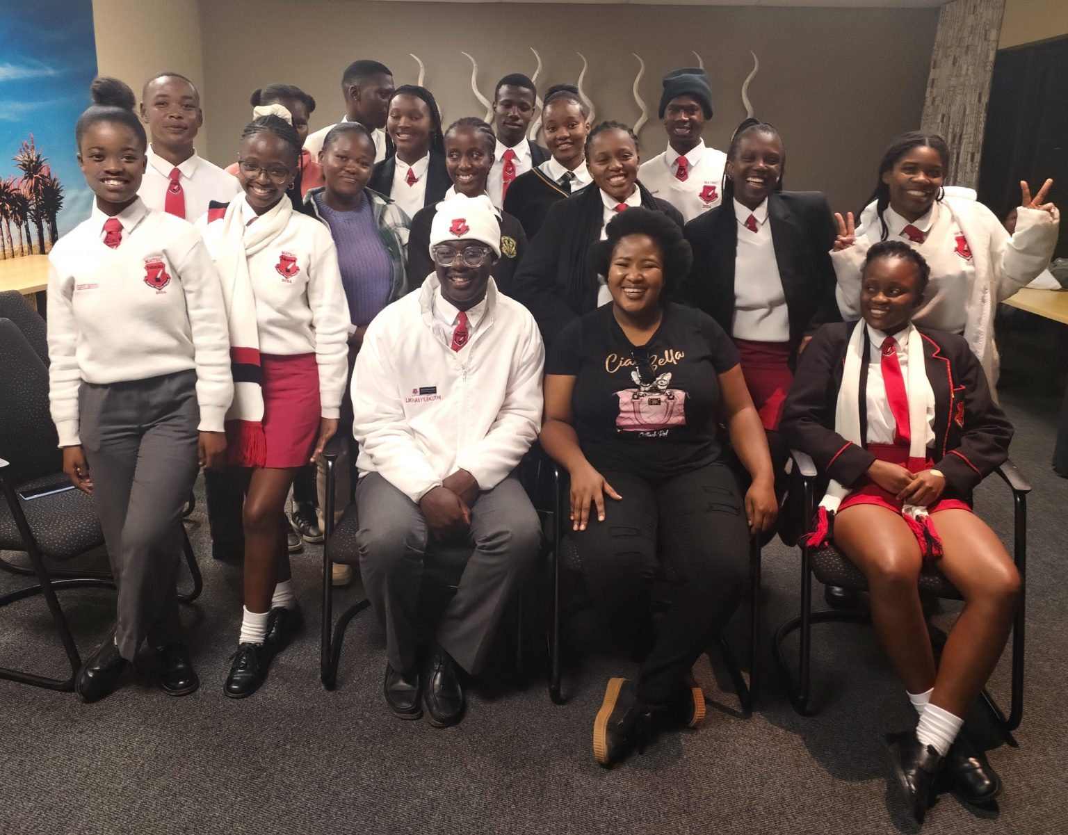 Sixteen Ntsika and Nyaluza High Schools learners pose with Inkululeko’s Nosi Dosi after the podcast on 27 February in the Africa Media Matrix at Rhodes University. Photo: Rod Amner