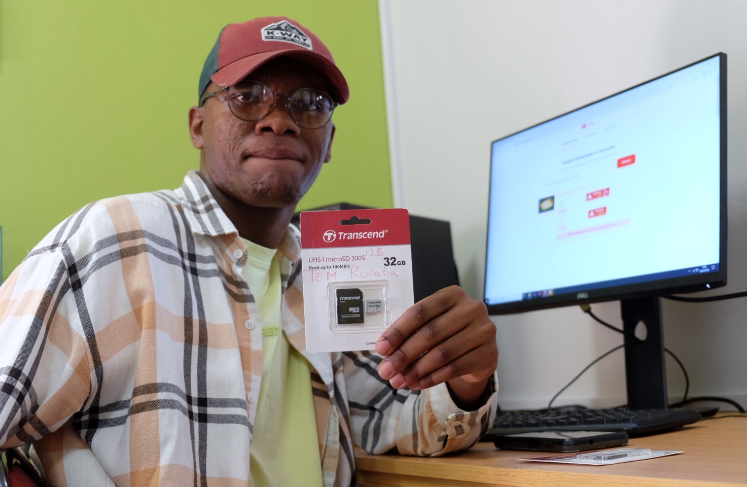 Social Employment Fund (SEF) worker Uzu Dikani shows off an SD card at the Social Innovation Hub at the Rhodes University Community Engagement centre. Photo: Rod Amner