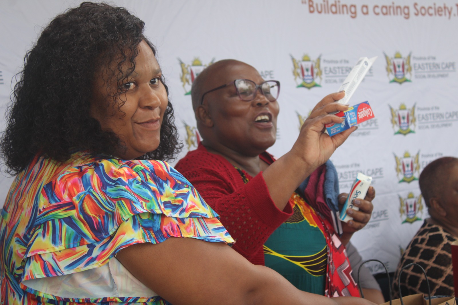 Social Development MEC Bukiwe Fanta, second from left, shows off some of the toiletries the department gave to needy learners at the two local schools they visited on Thursday. Pictured with the MEC at Amasango Career School is Sarah Baartman acting district director of social development, Namhla Tukela. Photo by Luvuyo Mjekula