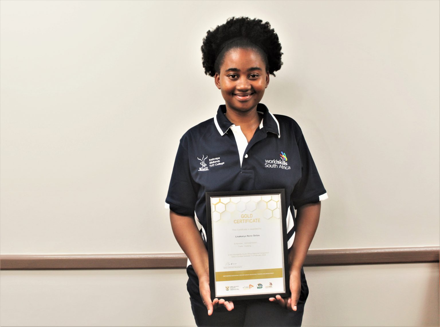 Lisakhanya Skitas holding a Gold Certificate for WorldSkills South Africa National Competition.