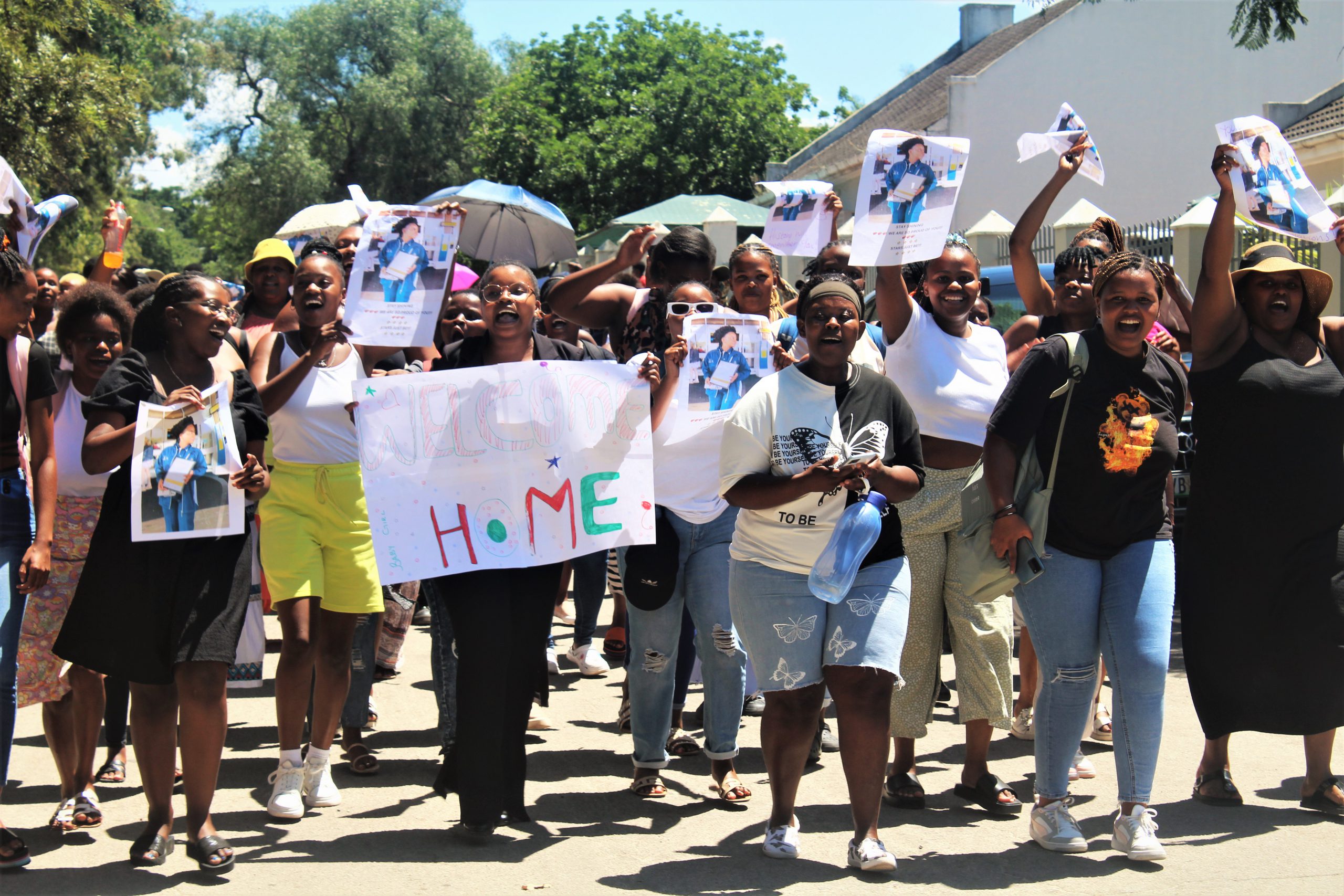 Eastcape Midlands Grahamstown TVET College students holding Skitas's pictures, singing and celebrating her achievement.