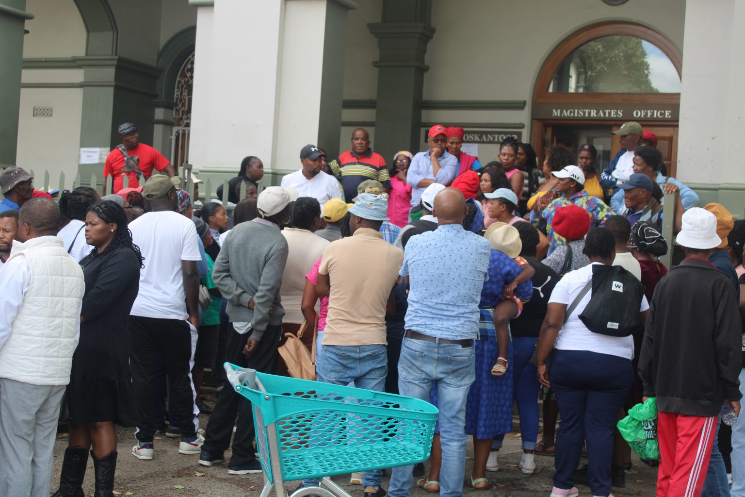 Family members and supporters of former Makana ward councillor Luyanda Sakata and three other men, discuss the murder case outside the Grahamstown Magistrate's Court on Wednesday. Photo: Luvuyo Mjekula