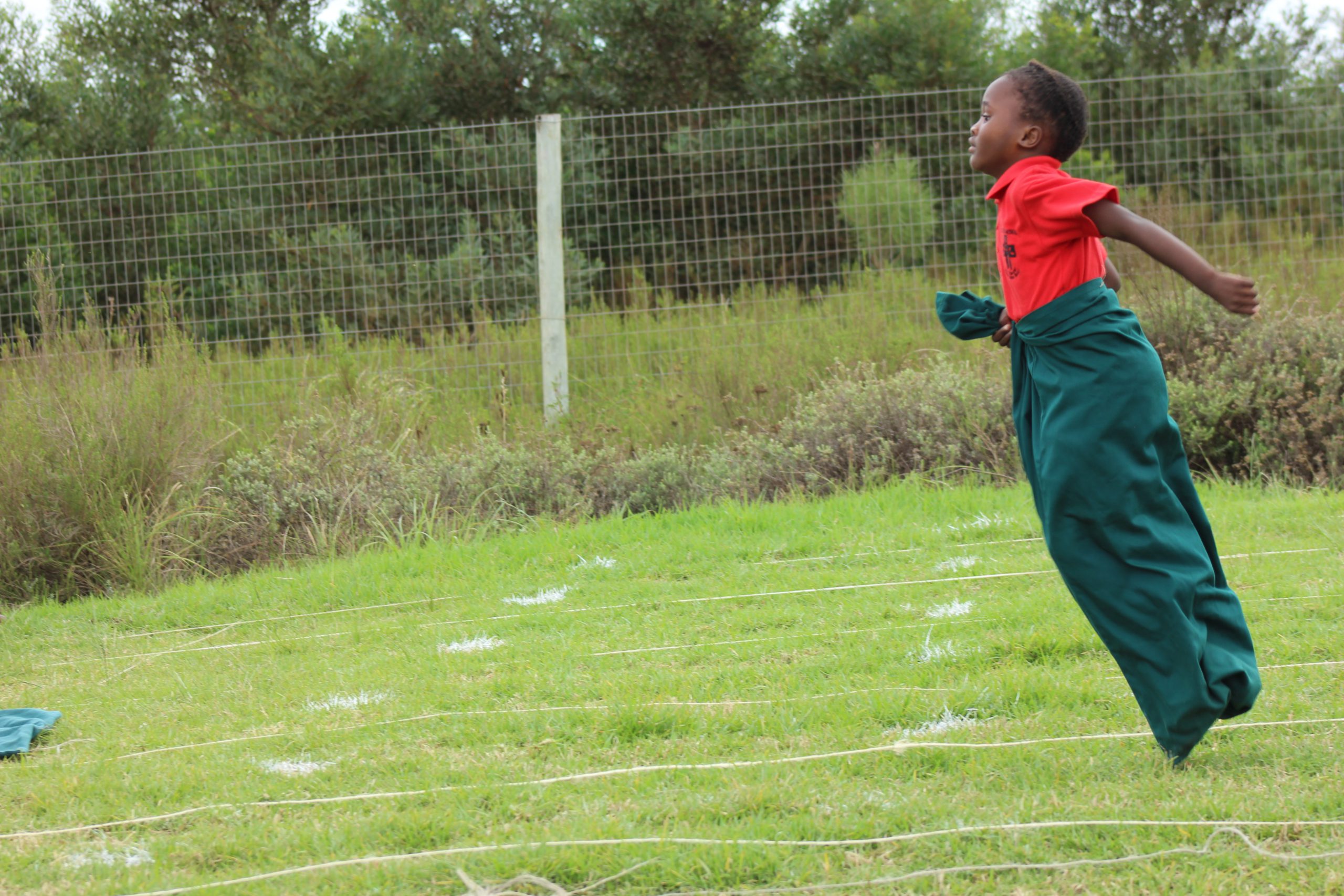 Holy Cross learners participating in sack racing during sports day. Photo: supplied