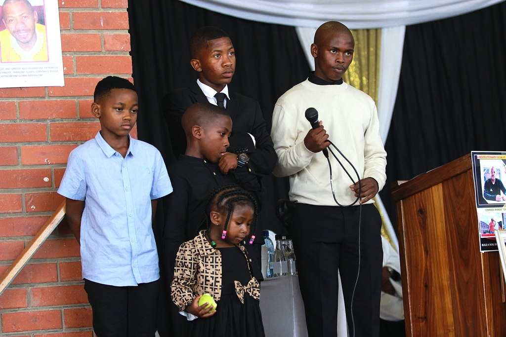 Ayanda Kota’s children, (blue shirt) Sima (tie), Sibalwethu, Imithandazo (middle), and the youngest, three-year-old Nosisa, representing their family at the funeral of their father. Photo: Steven Lang