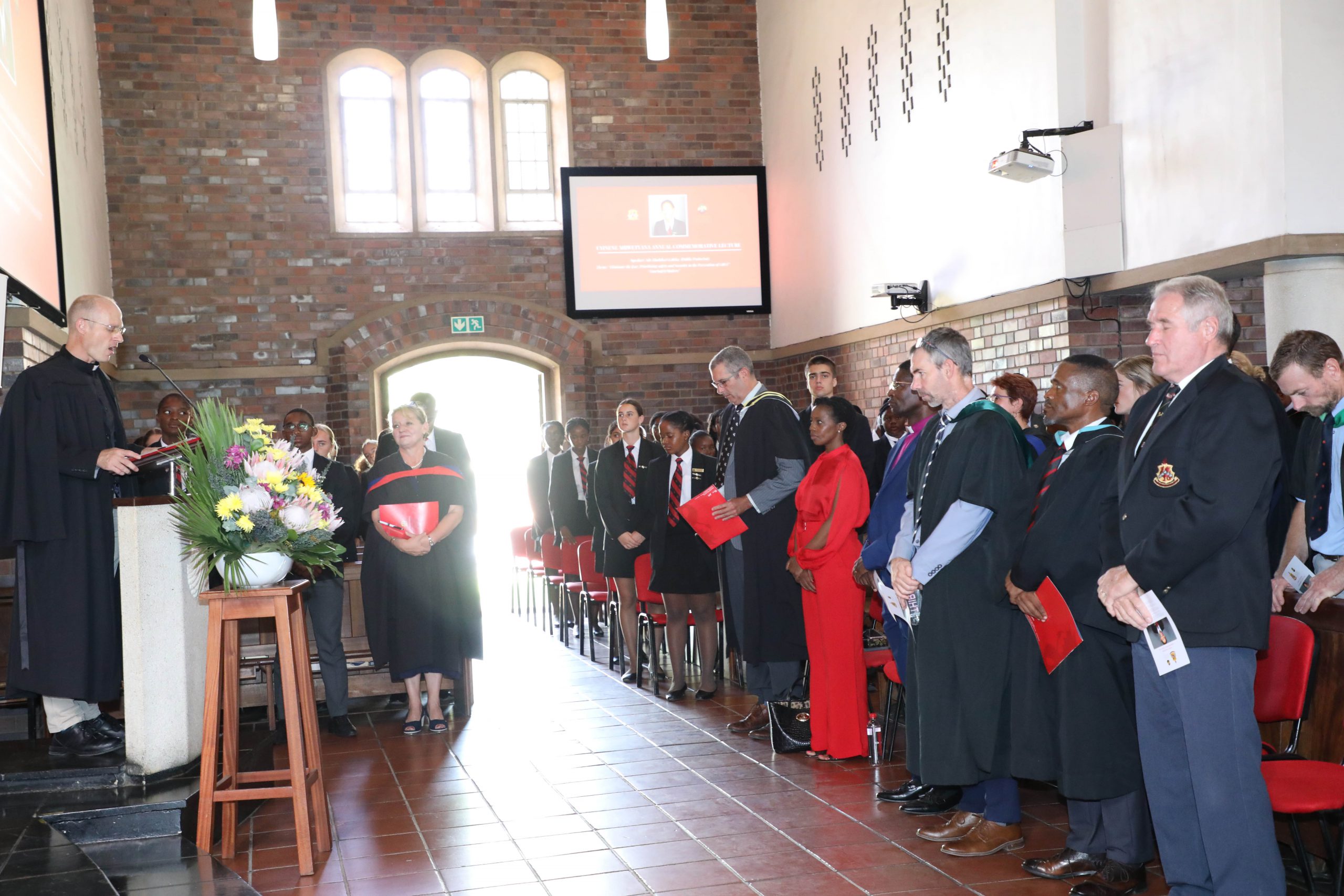 Kingswood learners, educators and advocate Nompilo Gcaleka praying at commemorative lecture of the late Uyinene Mrwetyane. Photo: Jackie Grove.