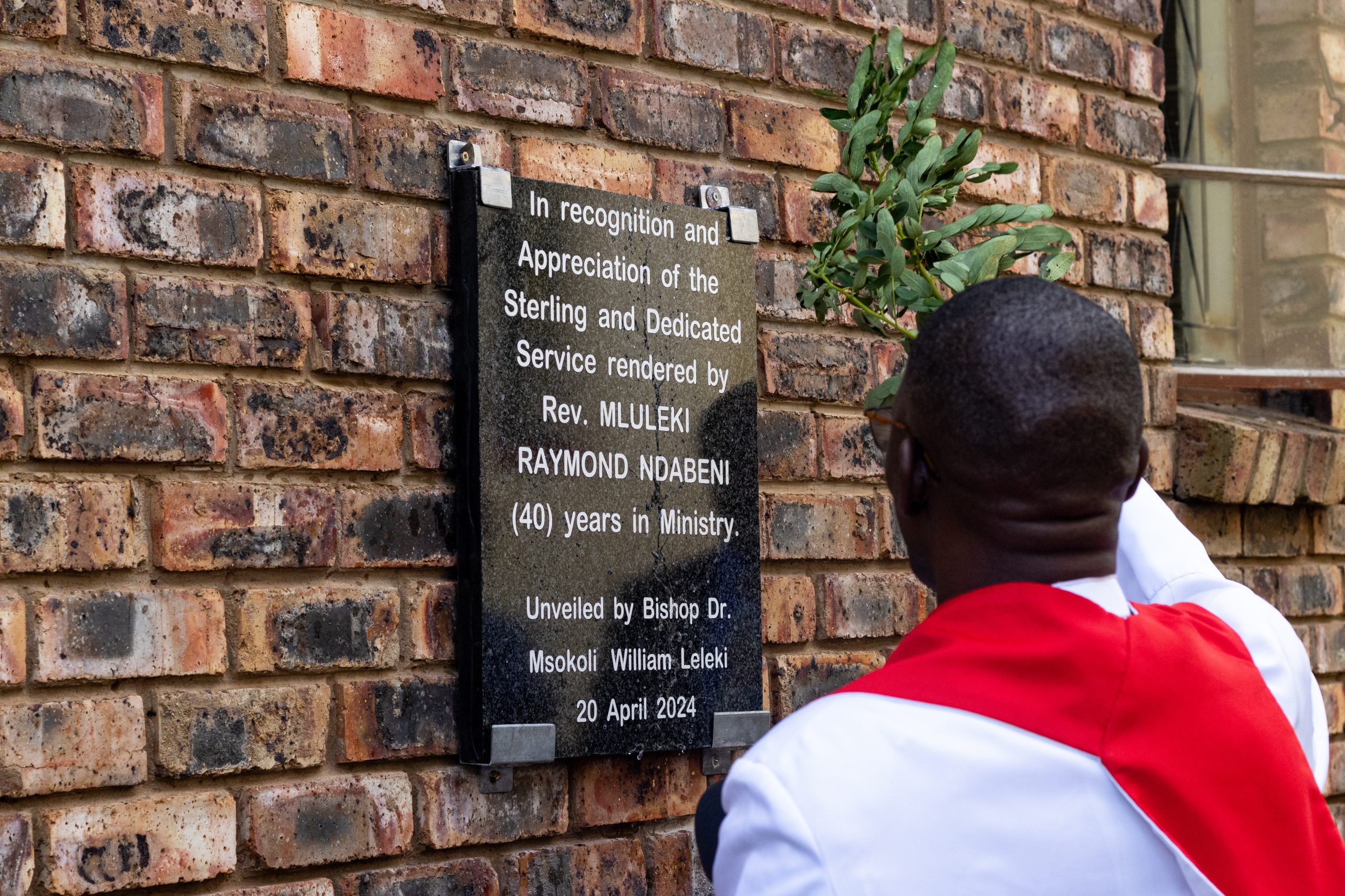Bishop Dr. Msokoli William Leleki blessing the plaque unveiled for the Mluleki Raymond Ndabeni Hall photo by RIkie Lai