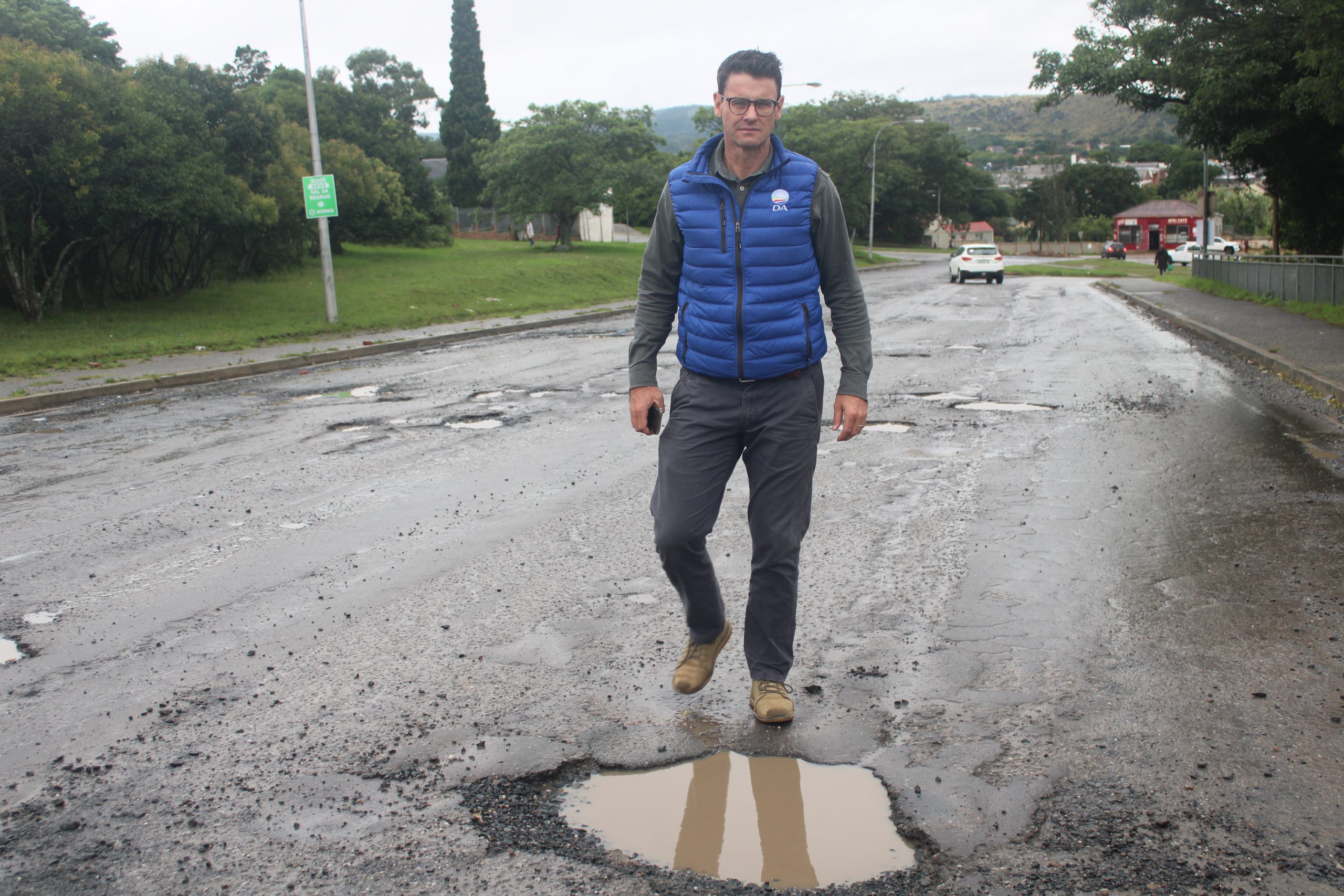 Member and a leader of DA after inspecting a pot hole filled with water.