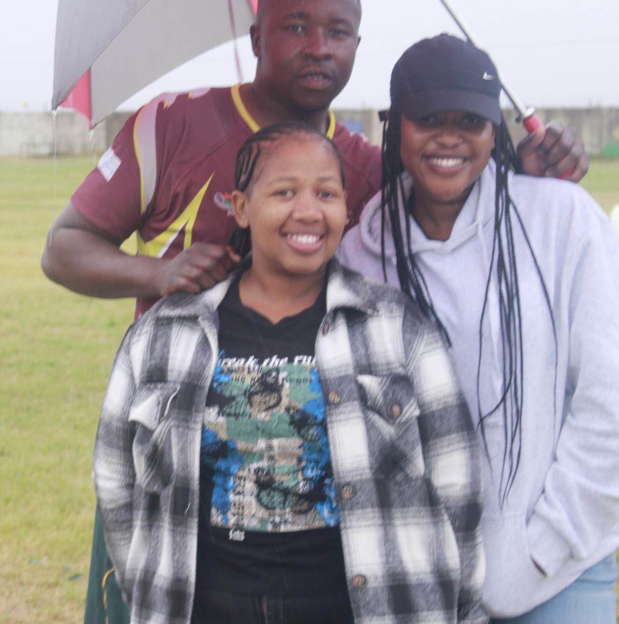 Some of the fans who braved the rainy weather to watch football