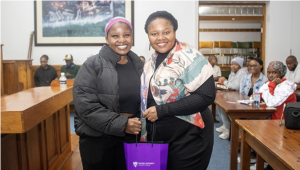 Dr Nomalanga Mashinini (right) accepts a gift from a student at her lecture