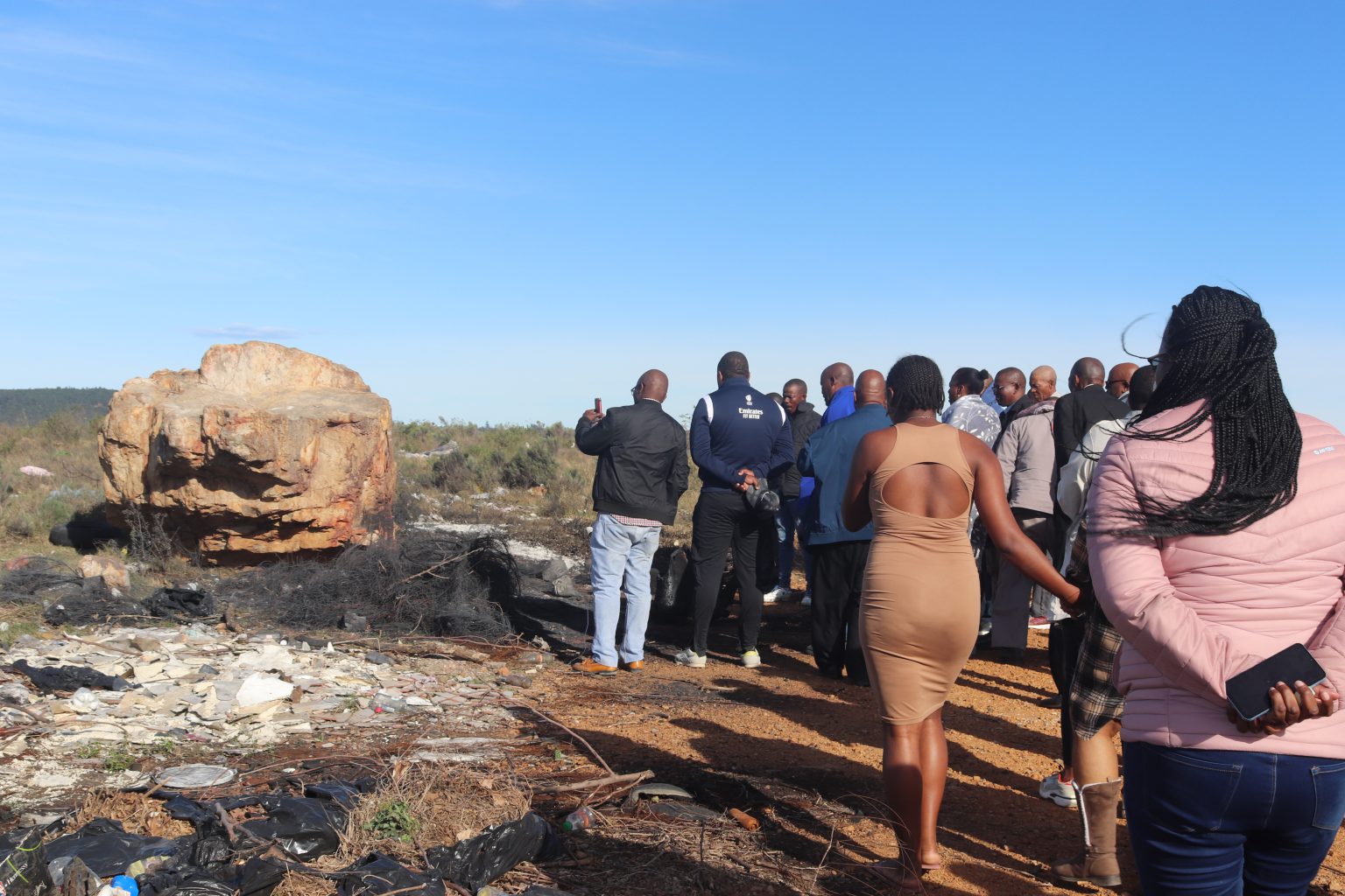 The Nyhweba family and community members at eBakhweteni field where Kungawo Nyhweba was murdered and burnt, allegedly by her ex-boyfriend, Xolani Gotyi. Photo: Khanyisa Khenese