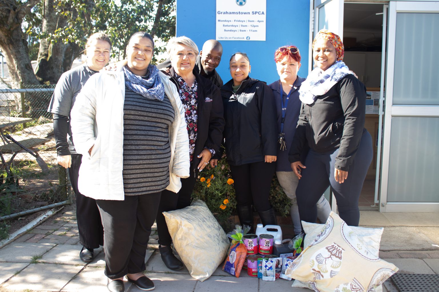 Pam Golding Properties' staff members, from left, Nicolette Sahd, Livona Adriaan, Charmaine Els, Odwa Simayile, Kirby Langson, Lee Matthews (SPCA) and Lorna Ganyile, at the SPCA in Makhanda on Thursday to mark Mandela Day. Photo: Amahle Cele