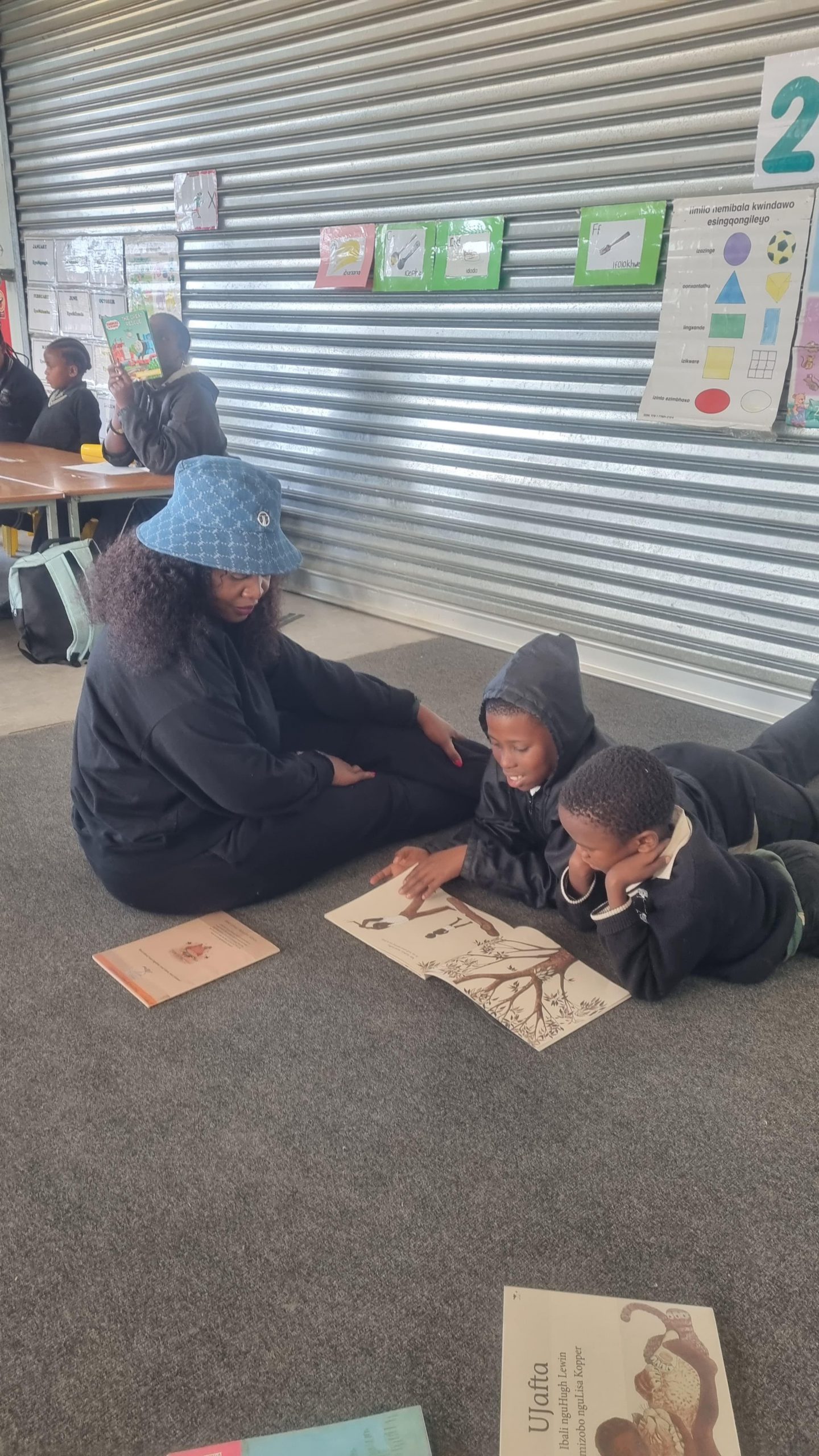 Dr. Nkomo reading for Grade 3 pupils at D.D Siwisa on Mandela day in 2024.Photo:Supplied 