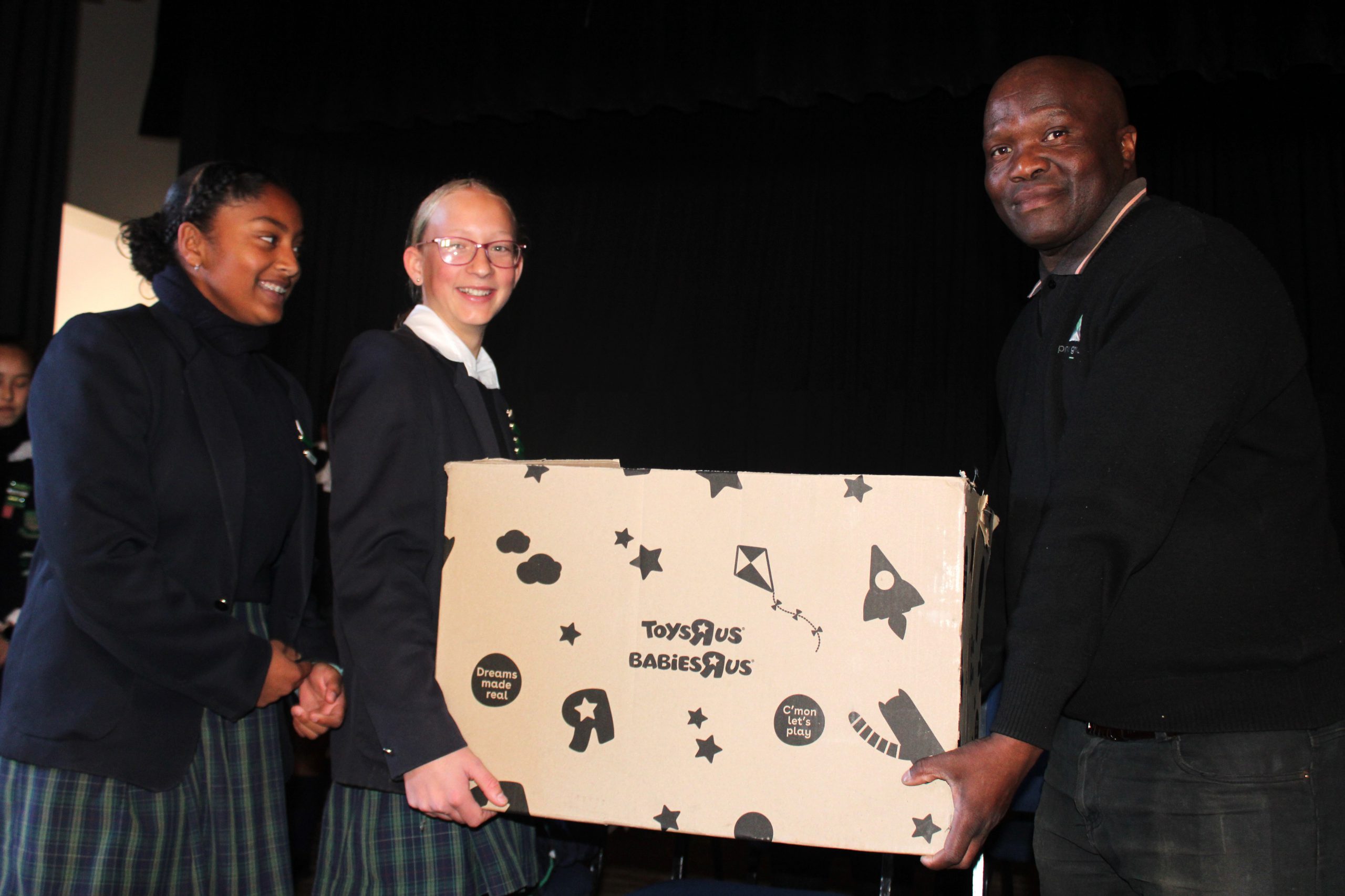 Grocott's Mail sports contributor and football fanatic, Chris Totobela (right) receives donations from Victoria Primary School pupils recently. Photo: Luvuyo Mjekula