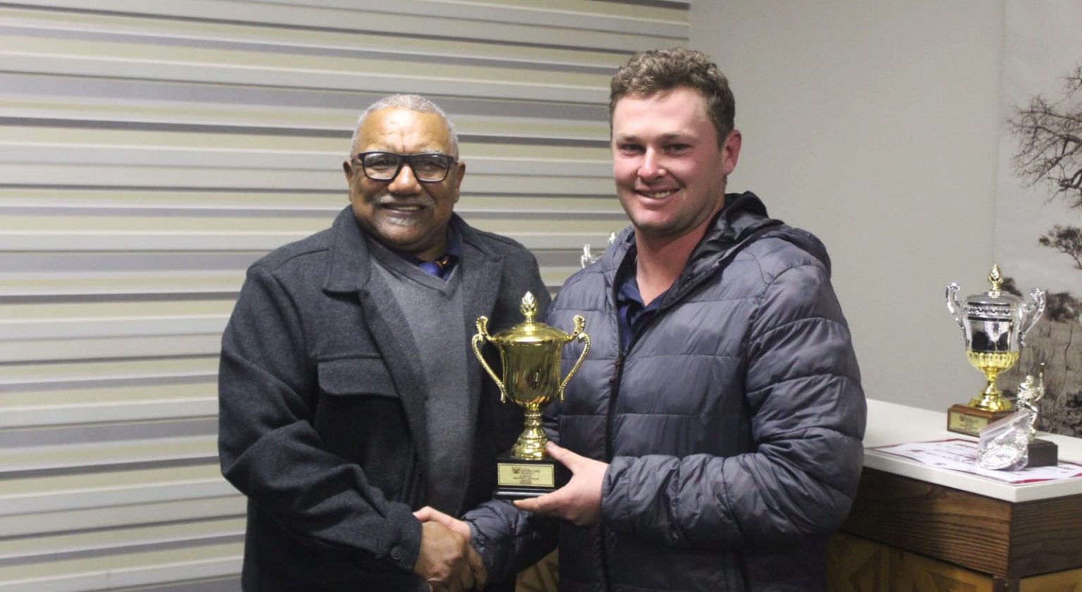 Grahamstown Cricket Board (GCB) president Leon Coetzee (left) hands over the GCB 1st League trophy to Salem captain Bradley Wilmot at the GCB annual general meeting and awards ceremony yesterday. Photo: Andy Jones Photography