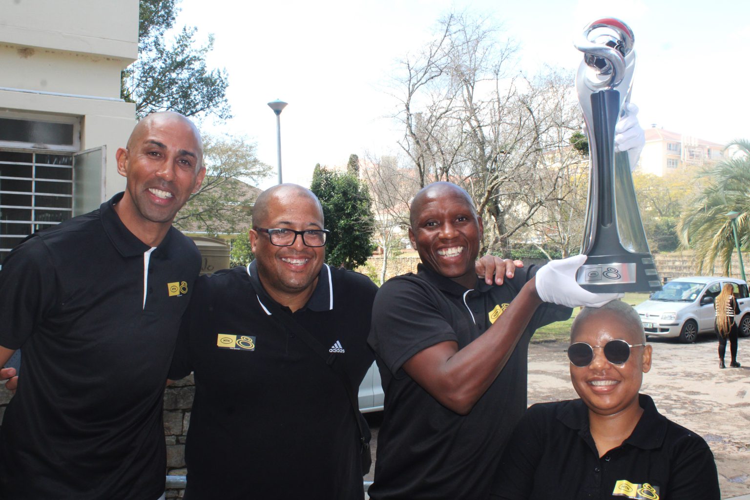 Former South African professional footballers and now MTN8 ambassadors Nathan Paulse (left) and Njabulo Manqana (second from right) joined by MTN staffers during the trophy tour outside the RMR studio at Rhodes University on Thursday. Photo: Luvuyo Mjekula