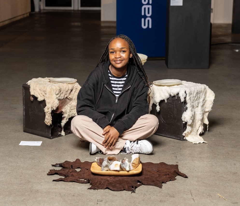 Rhodes University's Honours in Fine Art student Snelihle Asanda Maphumulo with her artwork at the Pretoria Art Museum where she was announced as a Sasol New Signatures Merit winner recently. Photo: Supplied