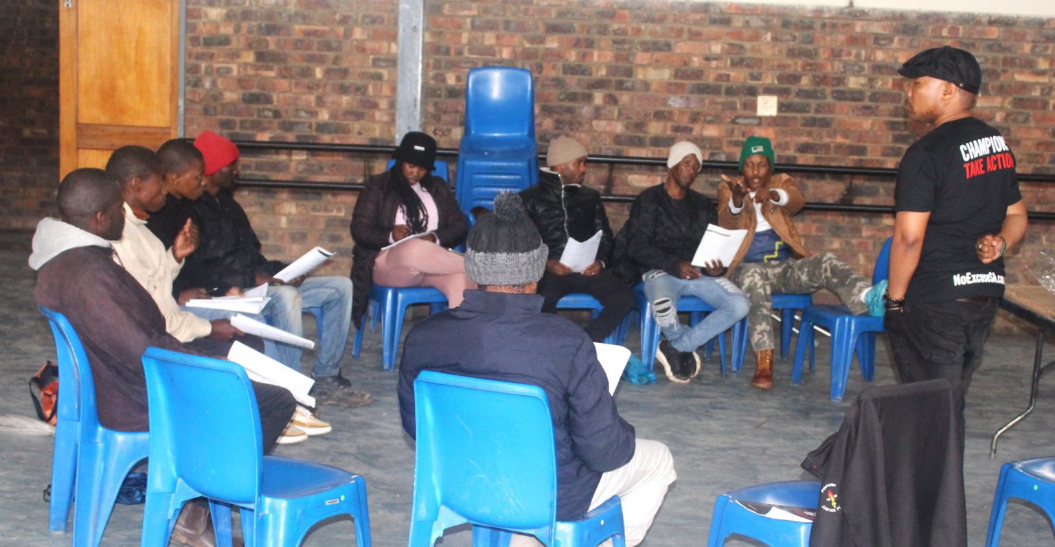 A group of Makhanda men in conversation at BB Zondani Hall as part of an event titled 'Become a champion for change", featuring a dialogue on GBV and positive masculinity. Photo: Nandipha Twani