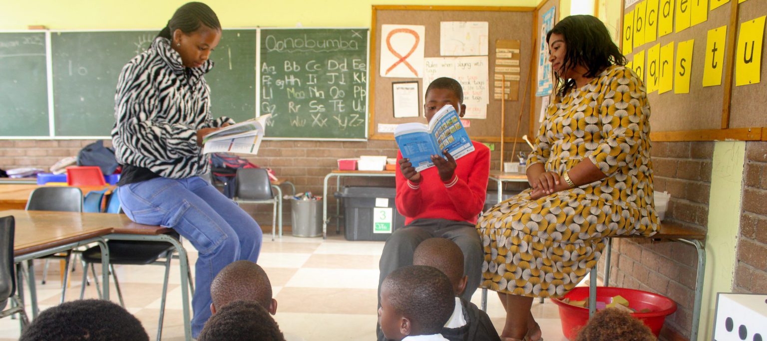 Centre for Social Development (CSD) team member Wendy Visani (left), at Tantyi Primary School with Grade R teacher Bongiwe Sifunda, helping pupils read to mark World Read Aloud Day 2025 on Wednesday, 5 February. Photo: Luvuyo Mjekula