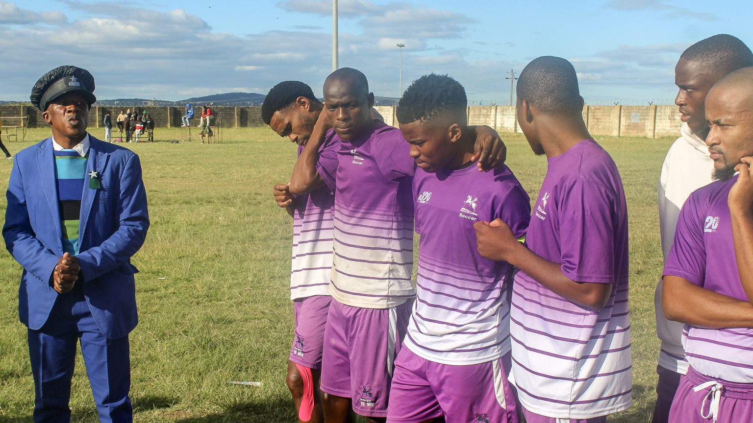Rhodes University FC coach Thembelani Mzalazala (left) addresses his team on Sunday after Riebeek City's walkover because the visitors brought only five players for the second leg of the crucial play-off match. In the first leg, Rhodes lost 3-0 to Riebeek City. Photo: Chris Totobela